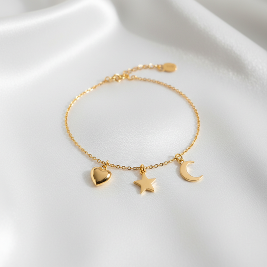 Gold charm bracelet with heart star and moon charms